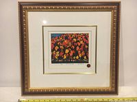 Full front view of framed artwork with decorative gold frame against white background, tape measure visible at base.