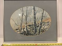 Front view of framed watercolor painting with ruler showing frame width