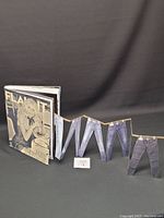 Foldout showing various denim jeans images arranged in accordion style extending from magazine.
