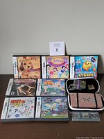 Top-down photo of the 10 Nintendo DS game cases and the carrying case with charger inside.