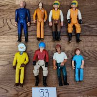 Top-down image of all 8 Fisher Price Adventure People figures showing full front details and colors.