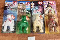Front view of four sealed Ty Beanie Babies Maple, Erin, Glory, Britannia in original blister card packaging