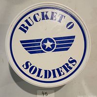 Top view of the bucket lid with 'Bucket O Soldiers' printed in blue with star symbol.