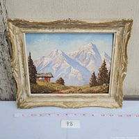Full front view of the framed mountain landscape painting showing the entire artwork and frame.