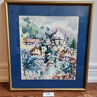 Framed watercolor painting featuring domed buildings and greenery, with a gold frame and blue mat.