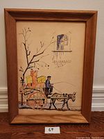 Front view of framed watercolor painting of man on a cart pulled by a donkey beside a tree and window.