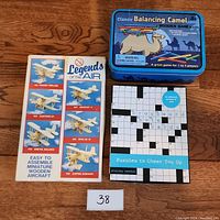 Lot showing the Legends of the Air wooden airplane kits, Classic Balancing Camel game tin, and crossword note cards book.