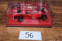 Side view of the 1:43 scale Ferrari F310 B model car in sealed clear case showing Michael Schumacher Collection branding and edition number.