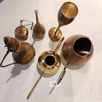 Top-down view of the six mixed metal vintage items on white surface, showing overall shapes and sizes