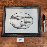 Front view of framed black and white art print showing two waterfowl in natural setting.
