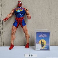 Full view of Spiderman figure and sealed Little Mermaid cards side by side.