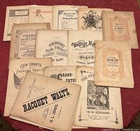 Full overview of the sheet music lot laid out on a table showing different titles and sizes.