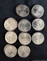 Pile of 2019 Idaho River of No Return quarters showing heads and tails, uncirculated condition