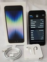 Apple iPhone 6s with box, showing front display with iOS screen, original charging cable, and Apple EarPods headphones.