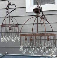 Two Italian chandeliers hanging, showing overall shape and condition with glass balls hanging on metal rods.