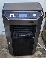 Frontal view showing control panel, vent, and power button, model and display visible.