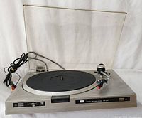 Full view of the Sansui FR-D35 turntable showing the platter, tonearm, clear dust cover, and power cord.