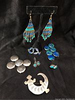 Pair of beaded earrings, silver pin shaped like a gecko, six blue stone button covers, six silver button covers with designs