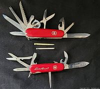 Both multi-tool knives side by side with all tools open, showing condition and details.