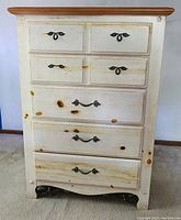 Front view of Vaughan Furniture Co five drawer chest showing hardware and wood knots.