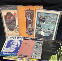 Front view of several vintage sheet music pieces showing distinct covers such as My Little Rose, Lily of the Valley, Moonlight on the Ganges, and others.