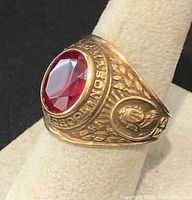 Angled side view showing laurel wreath motif and school seal