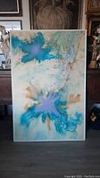Full frontal view of painting in narrow silver frame showing central abstract composition