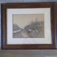 Framed black and white etching artwork featuring two hunting dogs in a landscape with water.
