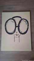 Photo of vintage canvas print featuring minimalist portrait of Iris Apfel with oversized round glasses.
