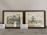 Both framed Parisian art prints by M Girard side by side showing size and reference cards