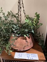 Copper cauldron with artificial ivy, showing front and side with hanging chain visible