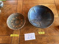 Top view of two handmade bowls, one smaller 9.5 inch with geometric in earth tones and one larger 13 inch with blue flower pattern.