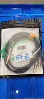 Photo of a new Tisino 1/4 inch TRS to RCA audio cable inside sealed clear plastic packaging with visible label and barcode. Cable is black with gold-plated connectors.