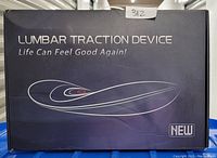 Box of lumbar traction device with product name and tagline visible