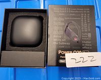 Power Q20 wireless sport earbuds box, charging case, and ear tips shown inside packaging foam.