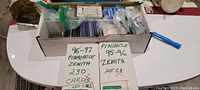 Box with sports cards including 96-97 Pinnacle Zenith and 95-96 Pinnacle Zenith collections labeled with card counts.