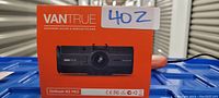 Front of orange retail box showing Vantrue logo and image of device