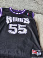 Full front view of Sacramento Kings black basketball jersey with number 55 and Nike and NBA logos visible.