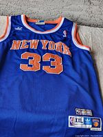 Front view of blue New York Knicks basketball jersey with Patrick Ewing number 33.