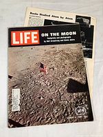 Front cover photo showing the Life magazine issue with the American flag on the moon.