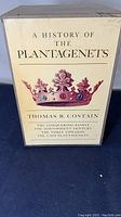 White slipcase box with title A History of The Plantagenets, author Thomas B. Costain and colored crown illustration on front, showing wear and aging.