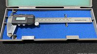 Full overview of the Mitutoyo Digimatic Caliper with digital display, stainless steel body, and case interior showing the blue foam lining.