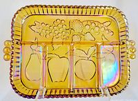 Full top view of marigold carnival glass divided serving dish showing fruit designs and three compartments.