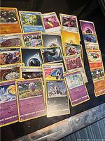 Photo showing 25 Pokémon cards including Poochyena, Mightyena, and Glaceon in decent, lightly used condition.