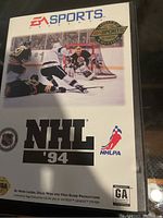 Front cover of the NHL '94 Sega Genesis game box featuring the EA Sports branding and an ice hockey scene.