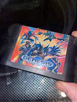Front view of the X Men Sega Genesis game cartridge showing label wear.
