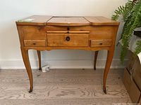Front view of vanity table with top panels closed