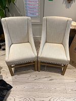 Front view of both chairs side by side on hardwood floor