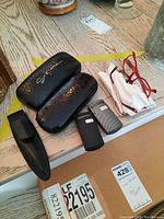Overall lot overview showing pen case, eyeglass cases, FG reading glass cases, reading glasses and cloth