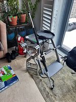 Overall view of Pilates Pro Chair, exercise stick, Pilates circle and boxed items on floor in room corner